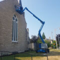 Boom lift used to paint windows at St. Andrew's Church Guelph Ontario